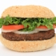 burger on a bun with lettuce tomato and onion