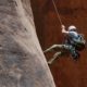 Man abseiling on rock face